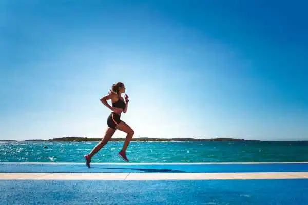 Woman running showing strong leg muscle Tewkesbury